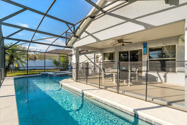 view of pool with ceiling fan, an in ground hot tub, a patio, and glass enclosure