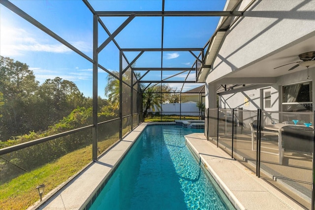 view of swimming pool featuring an in ground hot tub, ceiling fan, and a lanai