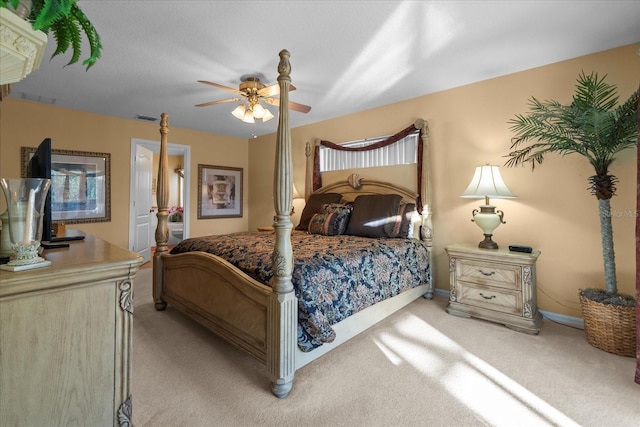 bedroom featuring connected bathroom, ceiling fan, and light colored carpet