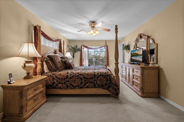 bedroom featuring carpet, a textured ceiling, and ceiling fan