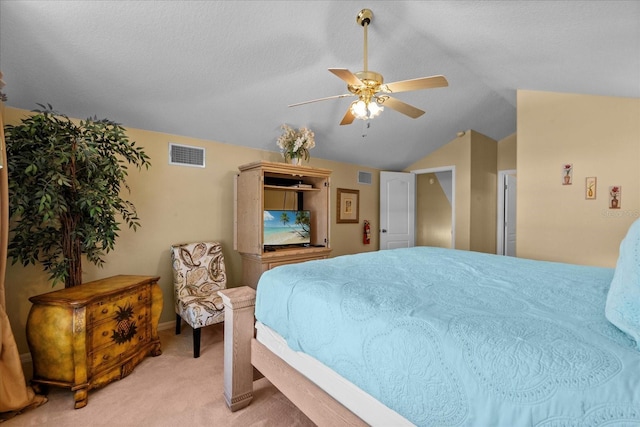 carpeted bedroom featuring ceiling fan and vaulted ceiling