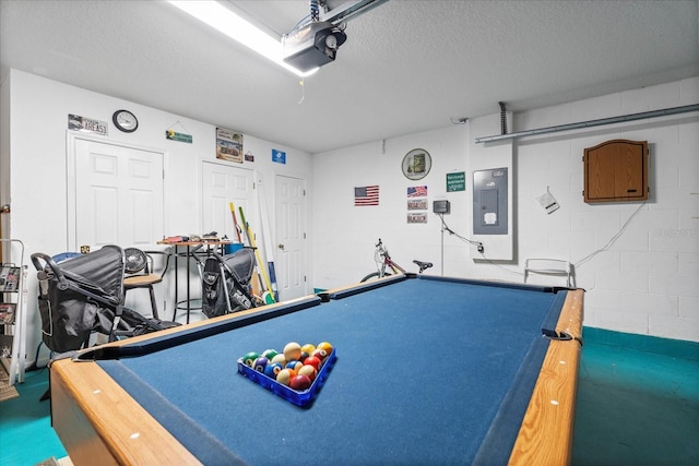 rec room featuring pool table, a textured ceiling, and electric panel