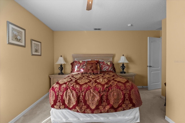 bedroom with ceiling fan and light colored carpet