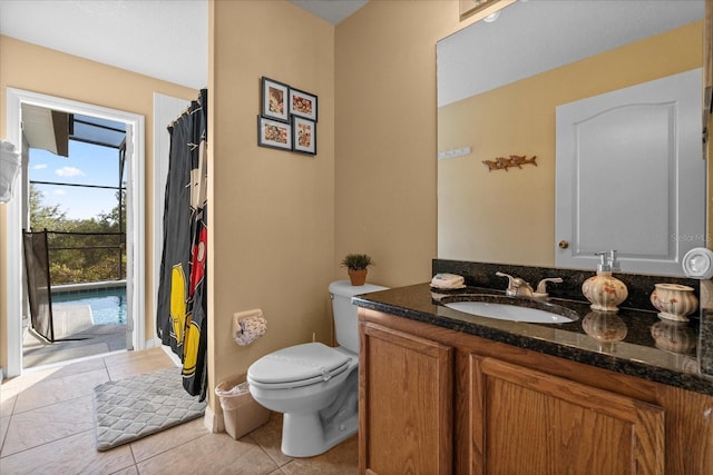 bathroom featuring tile patterned floors, vanity, and toilet