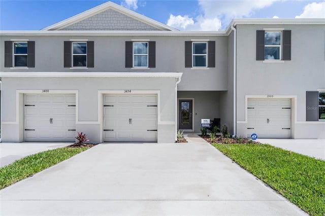 townhome / multi-family property featuring a garage