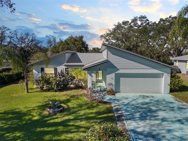 view of front of house with a lawn and a garage