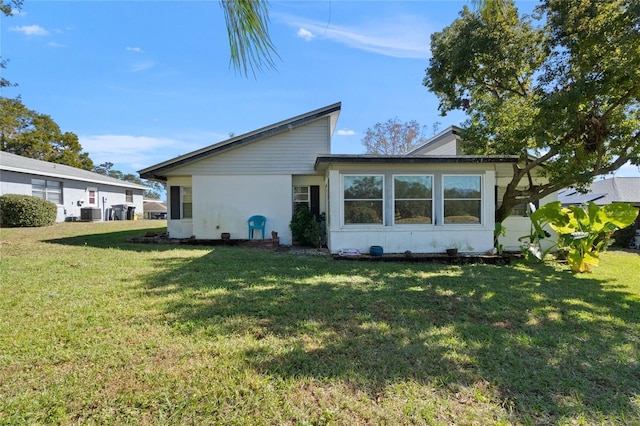 rear view of house featuring a yard