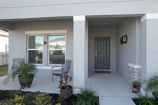 view of exterior entry with covered porch