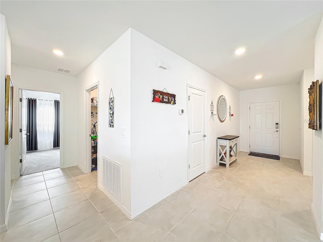 corridor featuring light tile patterned floors