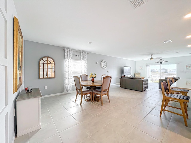 tiled dining area with ceiling fan