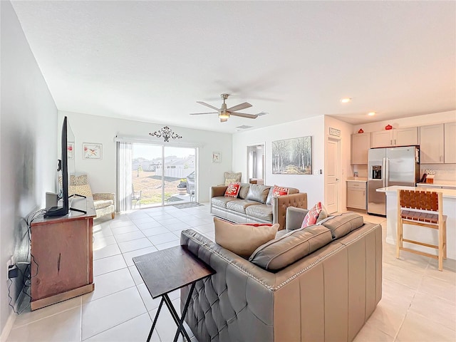 living room with ceiling fan and light tile patterned floors