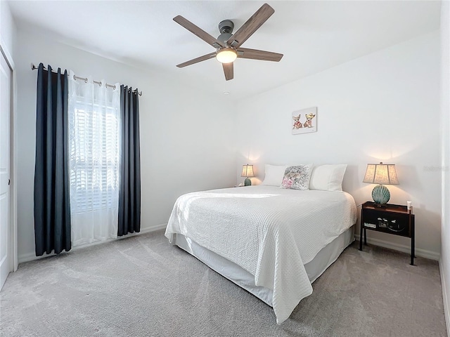 carpeted bedroom with ceiling fan