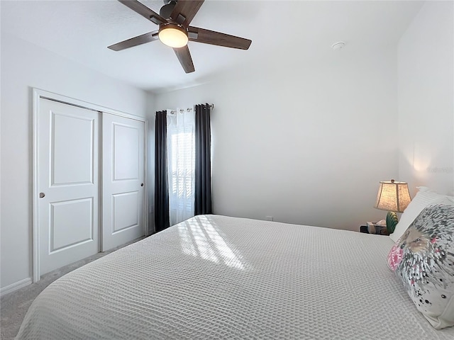 bedroom with ceiling fan, a closet, and carpet