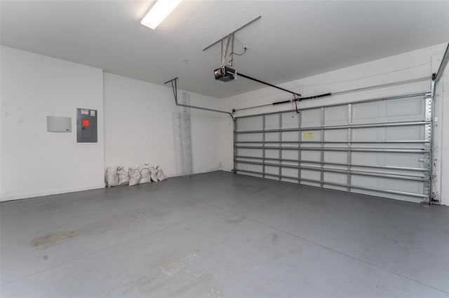 garage with a garage door opener and electric panel