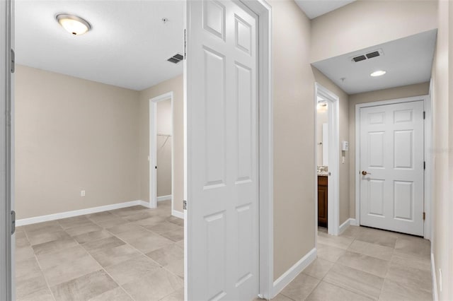 hallway with light tile patterned floors