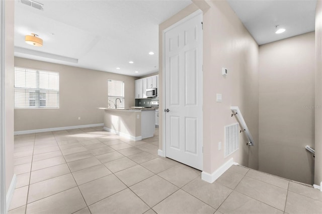 stairway with tile patterned floors