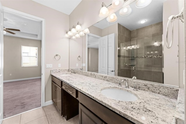 bathroom featuring tile patterned flooring, vanity, ceiling fan, and walk in shower