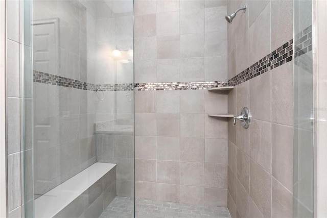 bathroom with tiled shower