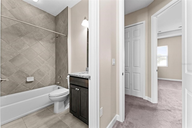 full bathroom with tile patterned flooring, vanity, toilet, and tiled shower / bath