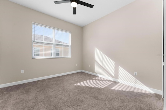 spare room with lofted ceiling, carpet floors, and ceiling fan