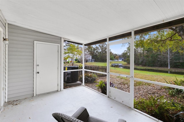 unfurnished sunroom with a water view