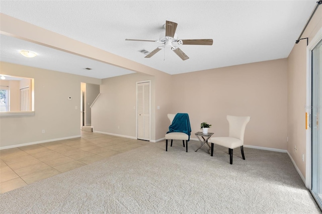 sitting room with ceiling fan and light tile patterned flooring