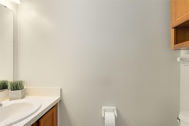 bathroom featuring toilet and vanity