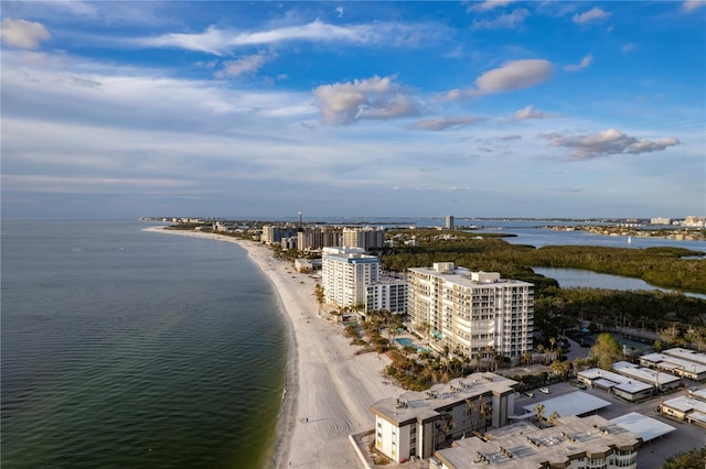 birds eye view of property with a water view and a beach view