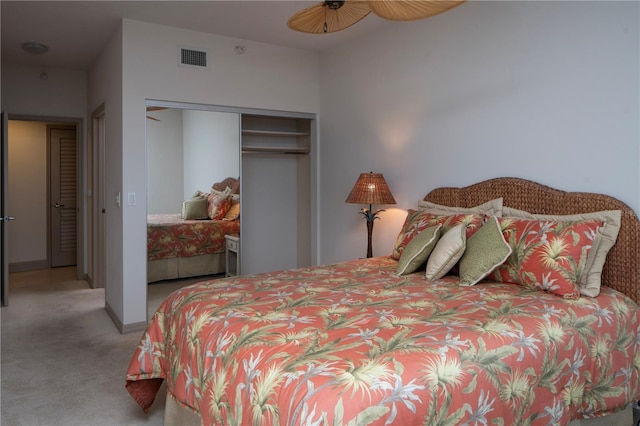 carpeted bedroom with ceiling fan and a closet