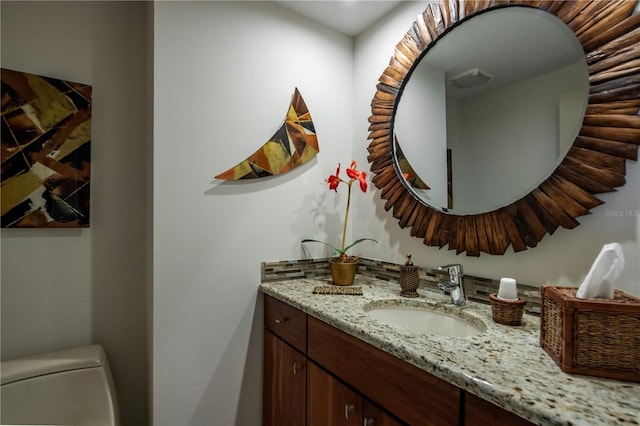 bathroom with vanity and toilet