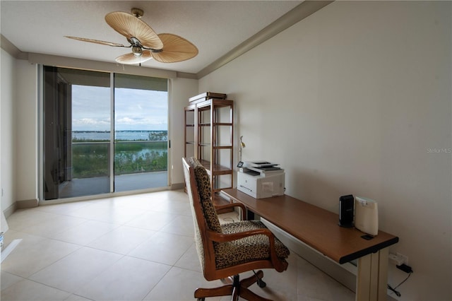 tiled home office featuring floor to ceiling windows, a textured ceiling, ceiling fan, crown molding, and a water view