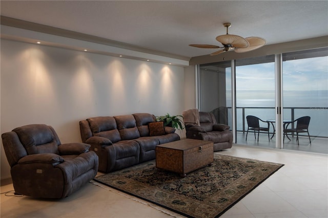 living room with a water view and ceiling fan