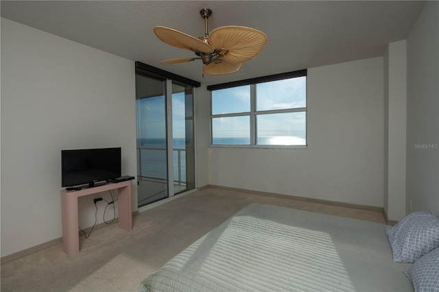 bedroom featuring access to exterior, ceiling fan, and light carpet