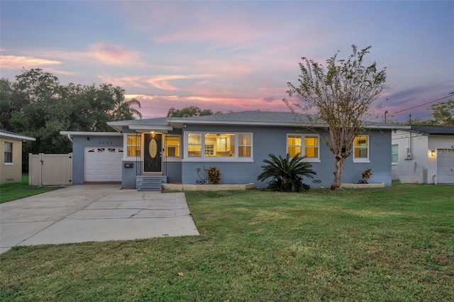 single story home with a yard and a garage