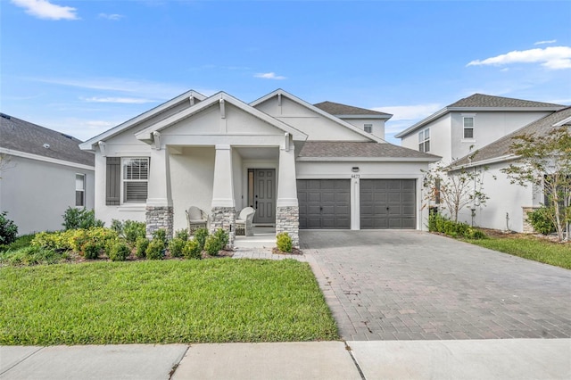 view of front of home with a front lawn and a garage