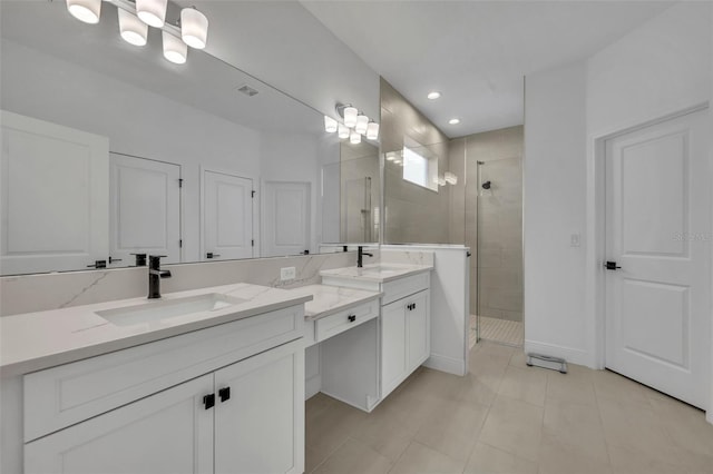 bathroom featuring tile patterned floors, vanity, and a shower with shower door