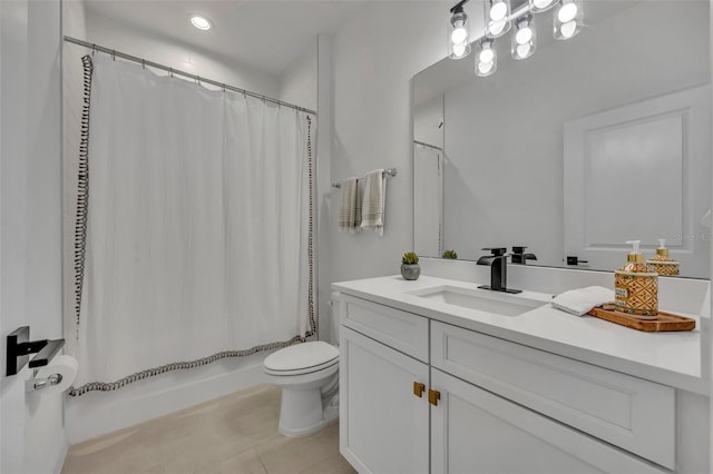 full bathroom featuring tile patterned flooring, shower / bath combo with shower curtain, vanity, and toilet