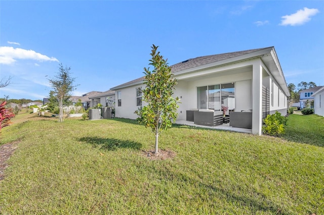 rear view of property with an outdoor living space and a yard