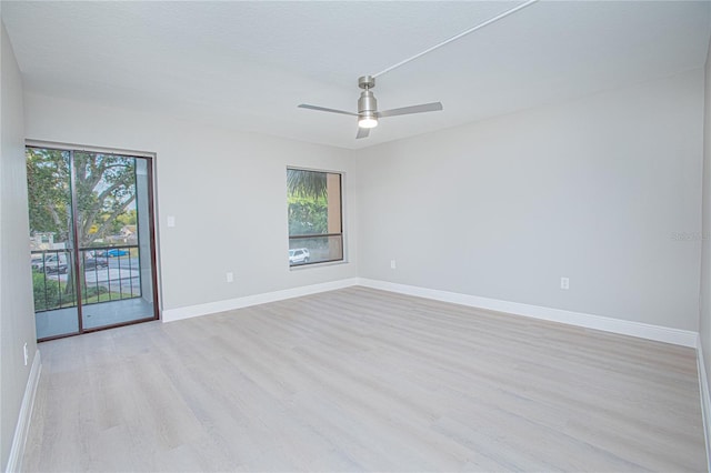 empty room with ceiling fan, a healthy amount of sunlight, light hardwood / wood-style floors, and a textured ceiling