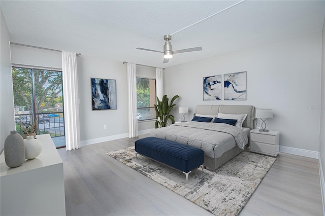 bedroom featuring ceiling fan, access to outside, and light hardwood / wood-style flooring