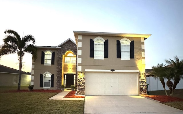 view of front of home featuring a lawn and a garage