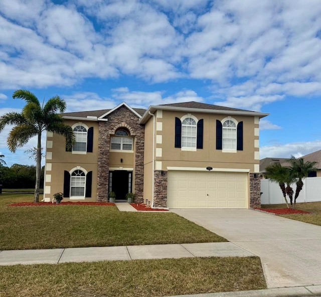 view of front of home featuring a garage and a front yard