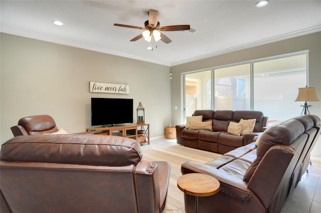 tiled living room with ceiling fan and crown molding