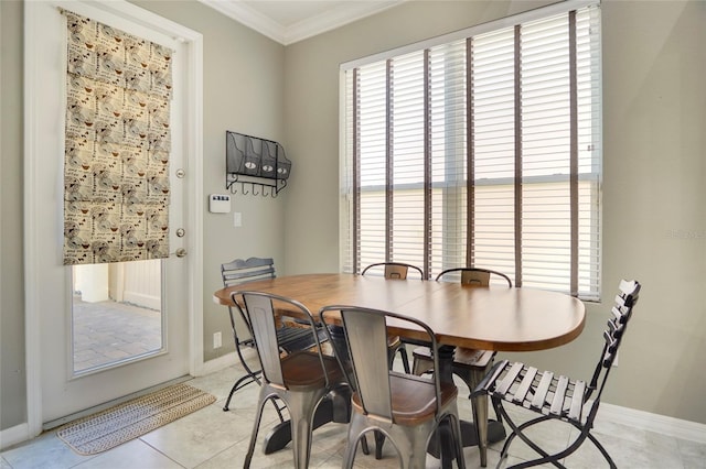 tiled dining space featuring ornamental molding