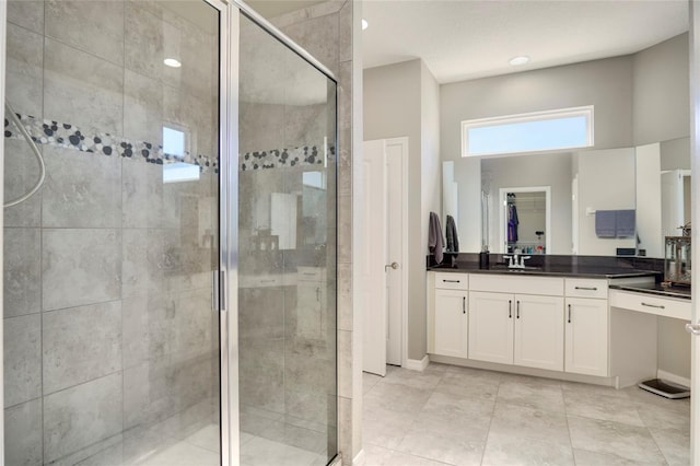 bathroom with vanity, tile patterned floors, and a shower with shower door