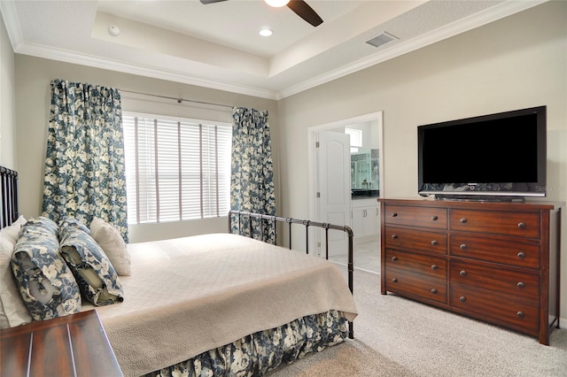 carpeted bedroom with a raised ceiling, ceiling fan, and crown molding