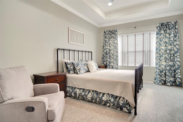 bedroom with light colored carpet, crown molding, and a tray ceiling