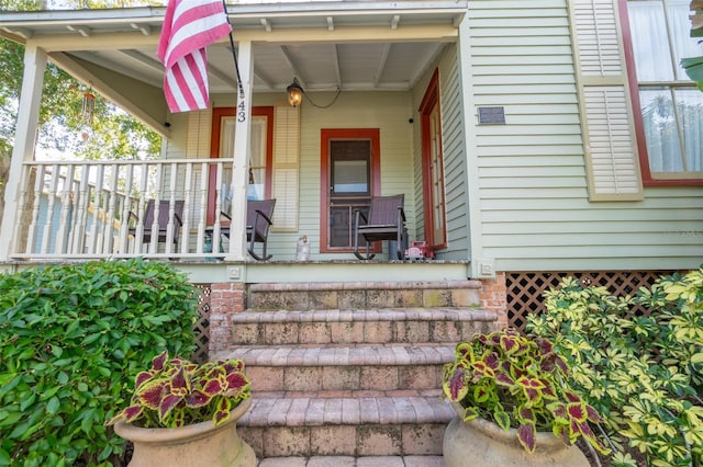 view of exterior entry with a porch