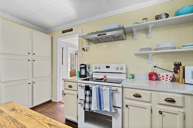 kitchen featuring white cabinetry, dark hardwood / wood-style flooring, ornamental molding, wall chimney range hood, and white appliances