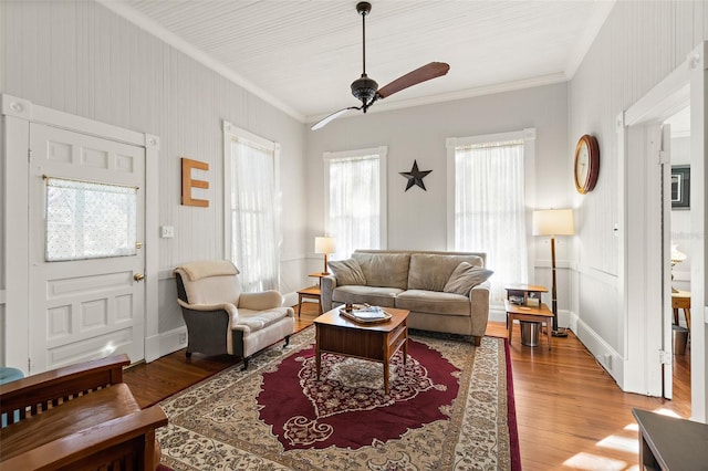 living room with crown molding, ceiling fan, and hardwood / wood-style floors